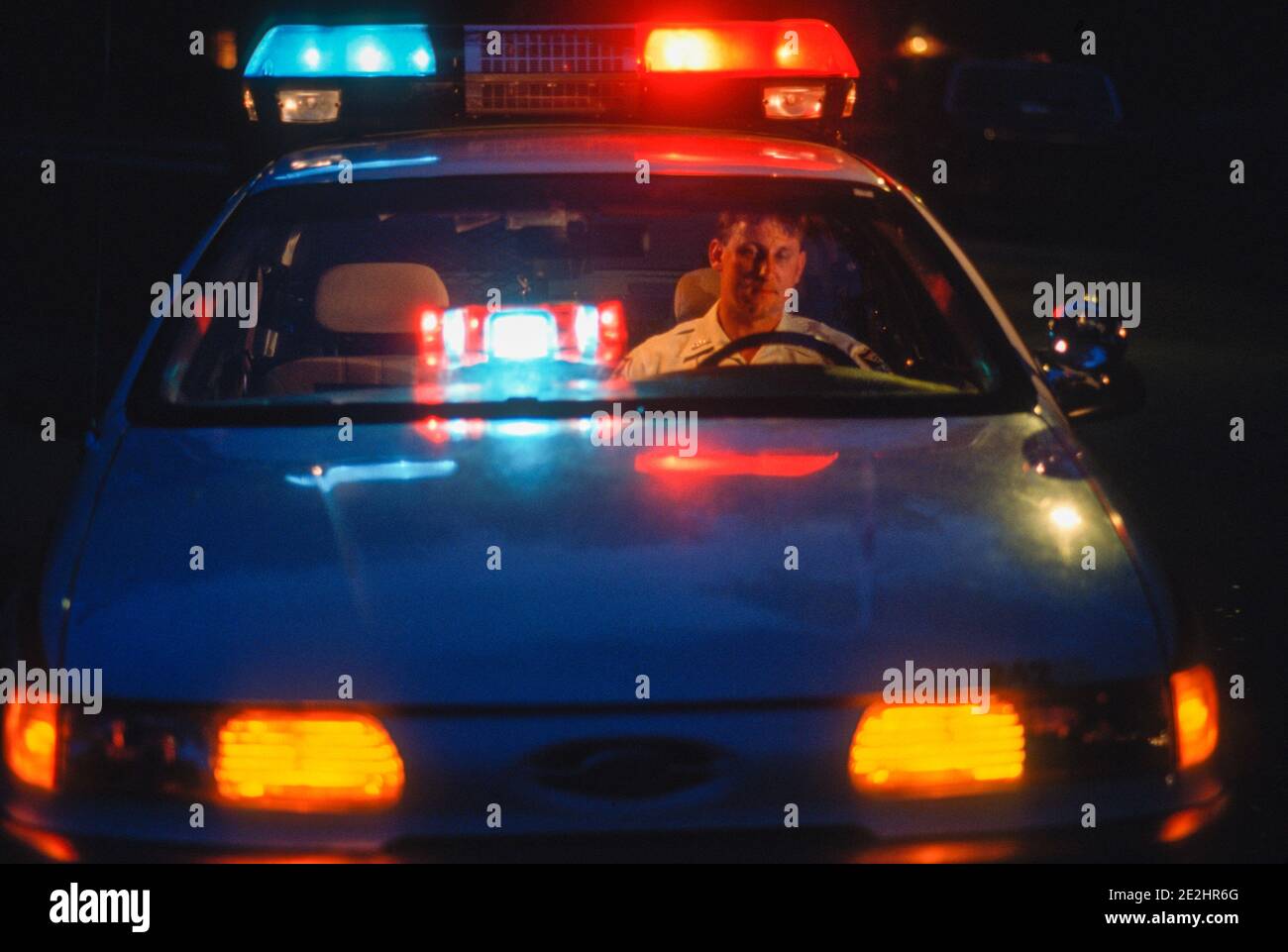Police Officer Works the night shift in his car, 1996, in Florida, USA Stock Photo