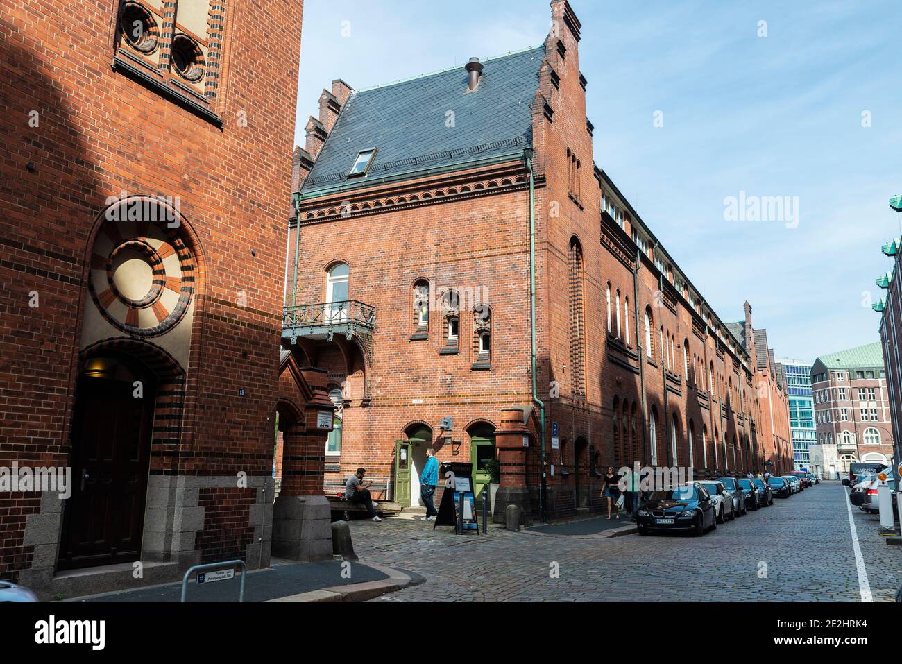 Hamburg, Germany - August 23, 2019: Old warehouses converted into offices and flats with people around in HafenCity, Hamburg, Germany Stock Photo