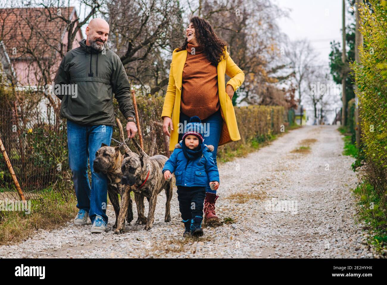 Family is taking a dogs for a walk and enjoying outdoor activities