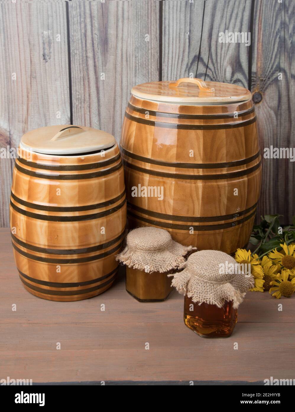 Sweet honey in barrel and jar with acacia flowers isolated on white Stock Photo