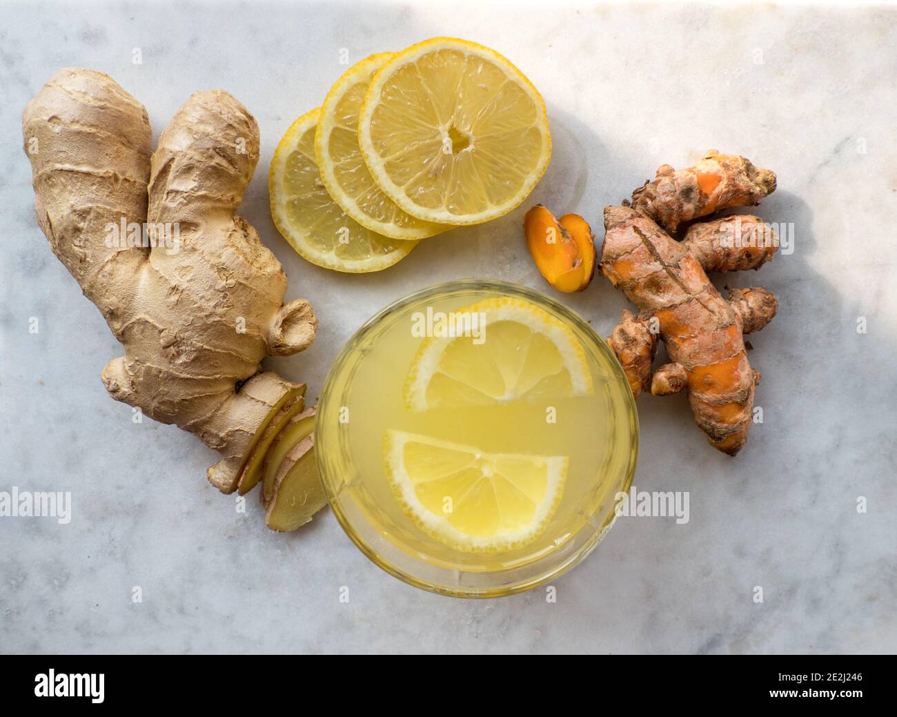 Top view of a glass of hot lemon and turmeric ginger tea, a healthy and naturally immune system boosting cold remedy Stock Photo