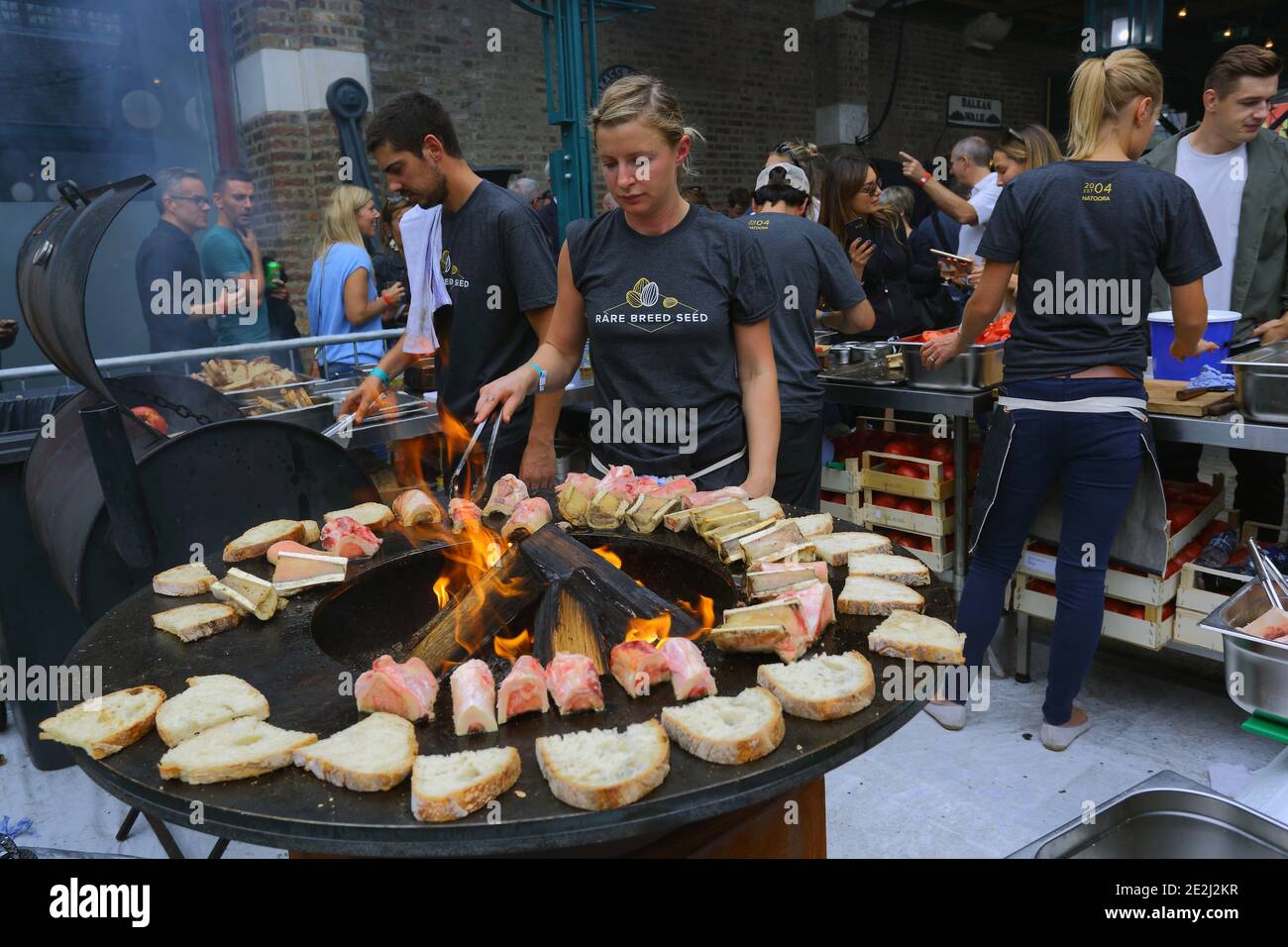 Meatopia in Tobacco Dock in London.chefs grilling on barbecue grill