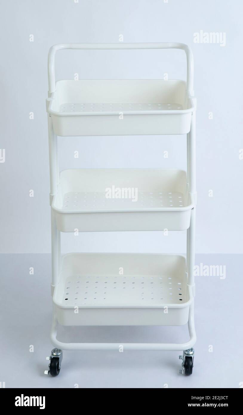 white plastic racks with wheels isolated on white background Stock Photo