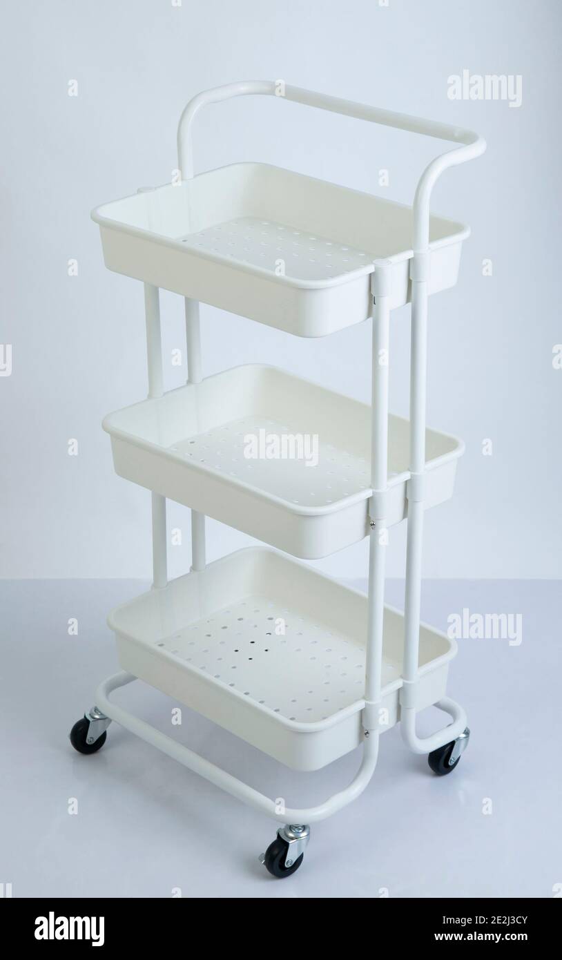 White plastic racks with wheels isolated on white background Stock Photo