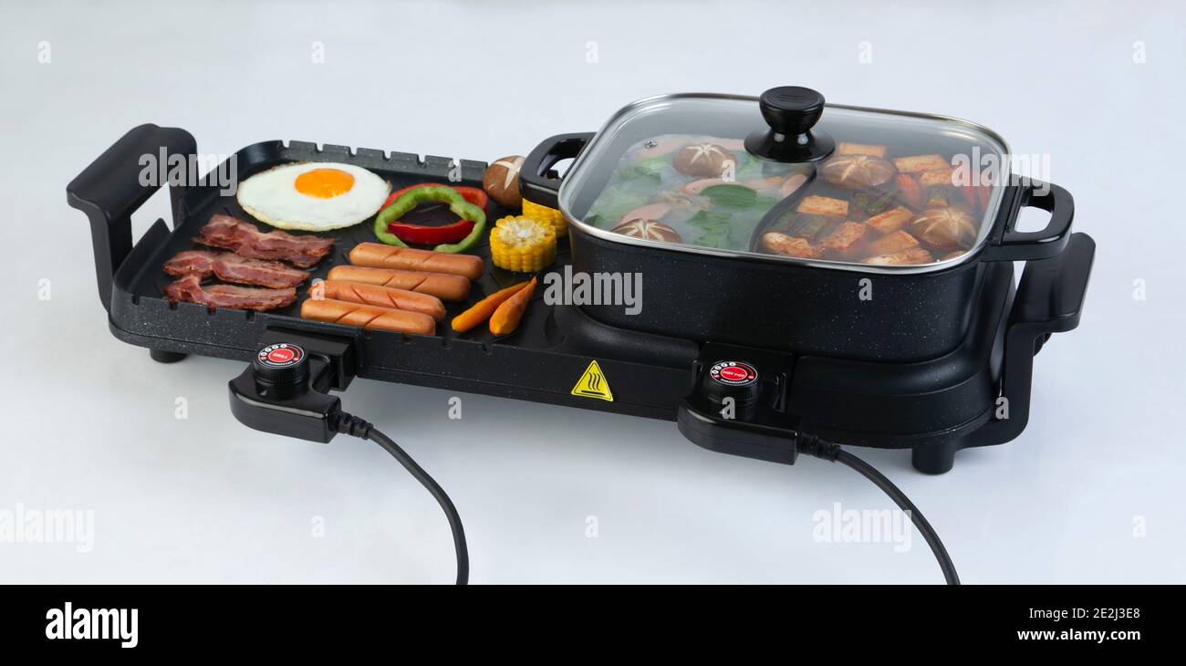 Multipurpose electric grill stove with food isolated on white background Stock Photo