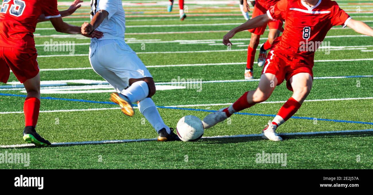 Free Stock Photo of Two footballers are fighting for the ball on the  football field