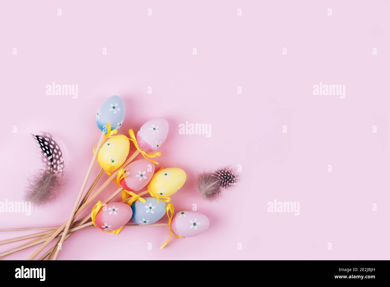Colorful Easter eggs over pink background. Top view with copy space Stock Photo