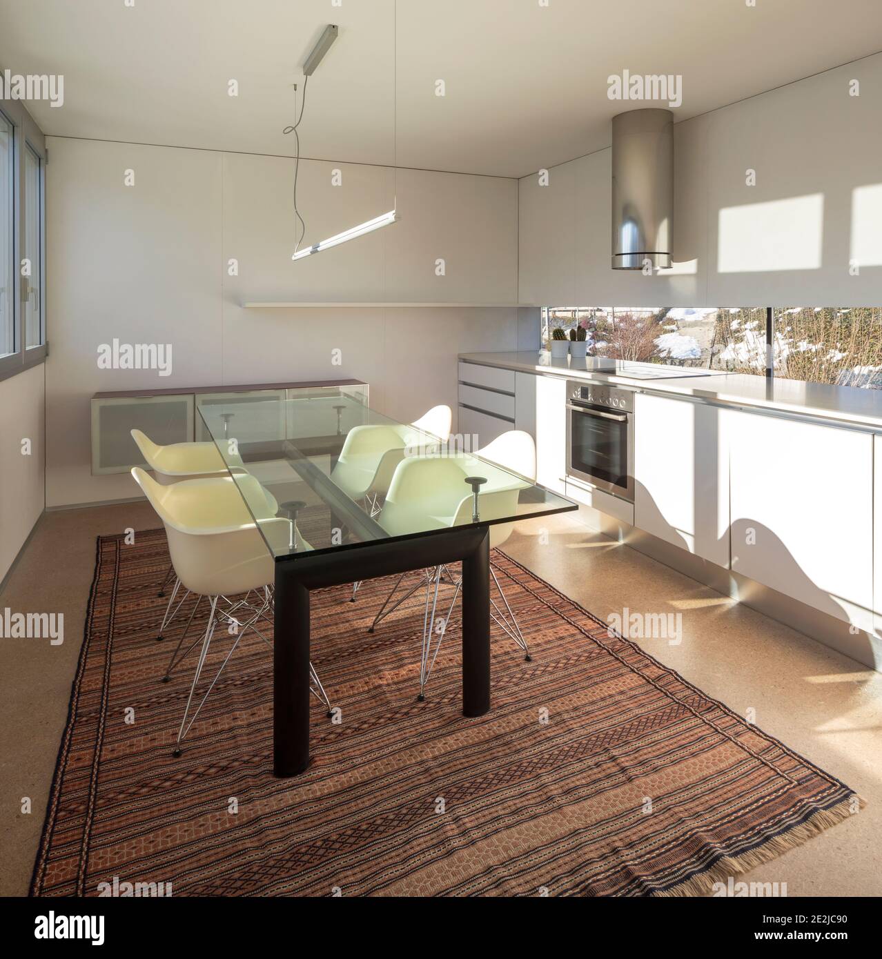 luxurious kitchen with dining table and four chairs inside Stock Photo