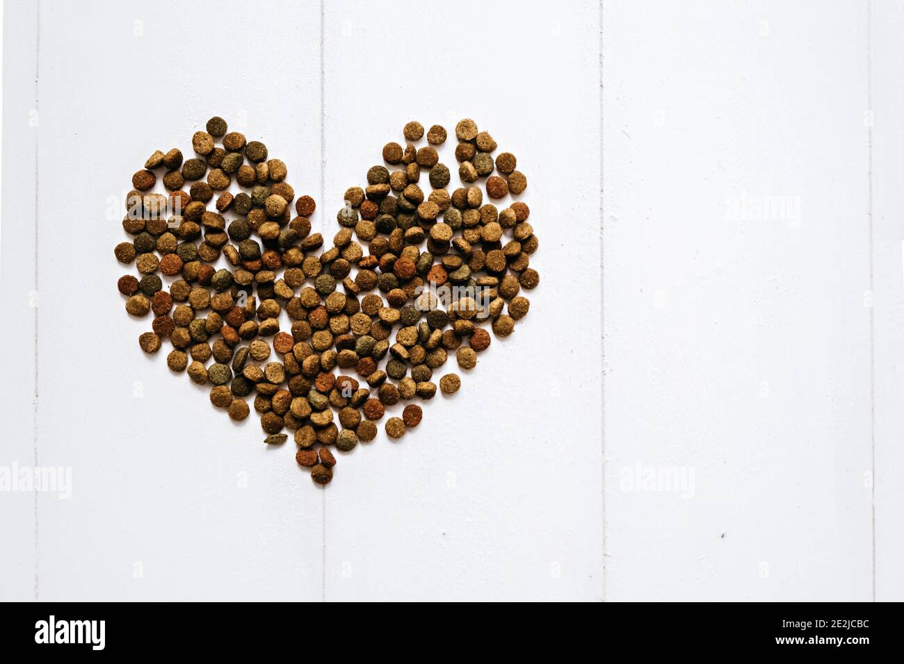 Heart shaped dry pet food. Food for cats and dogs. Taking care of pets