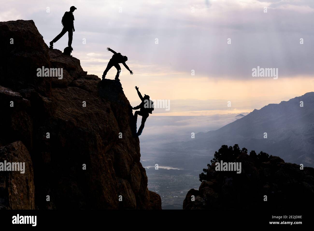 dangerous climbing, friend support and mountaineering Stock Photo Alamy