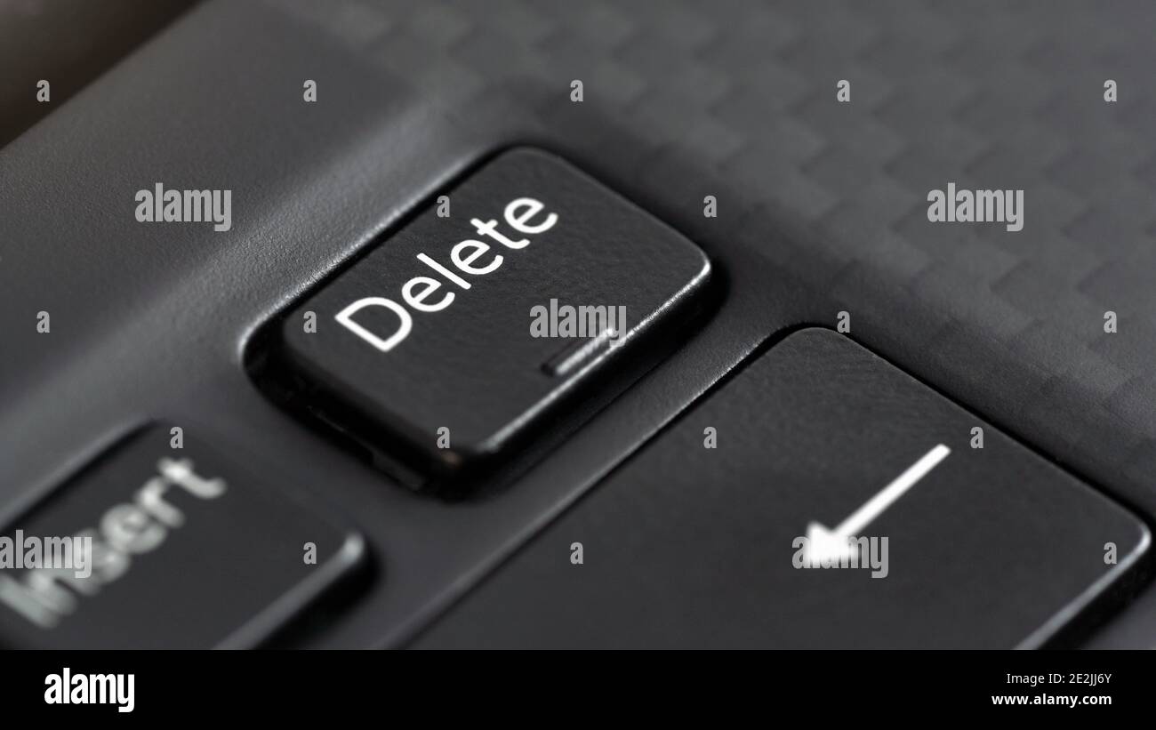 Closeup macro detail of Delete key on black laptop keyboard Stock Photo