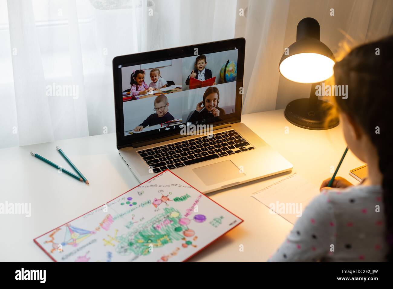 Little girl studying online using her laptop at home Stock Photo - Alamy