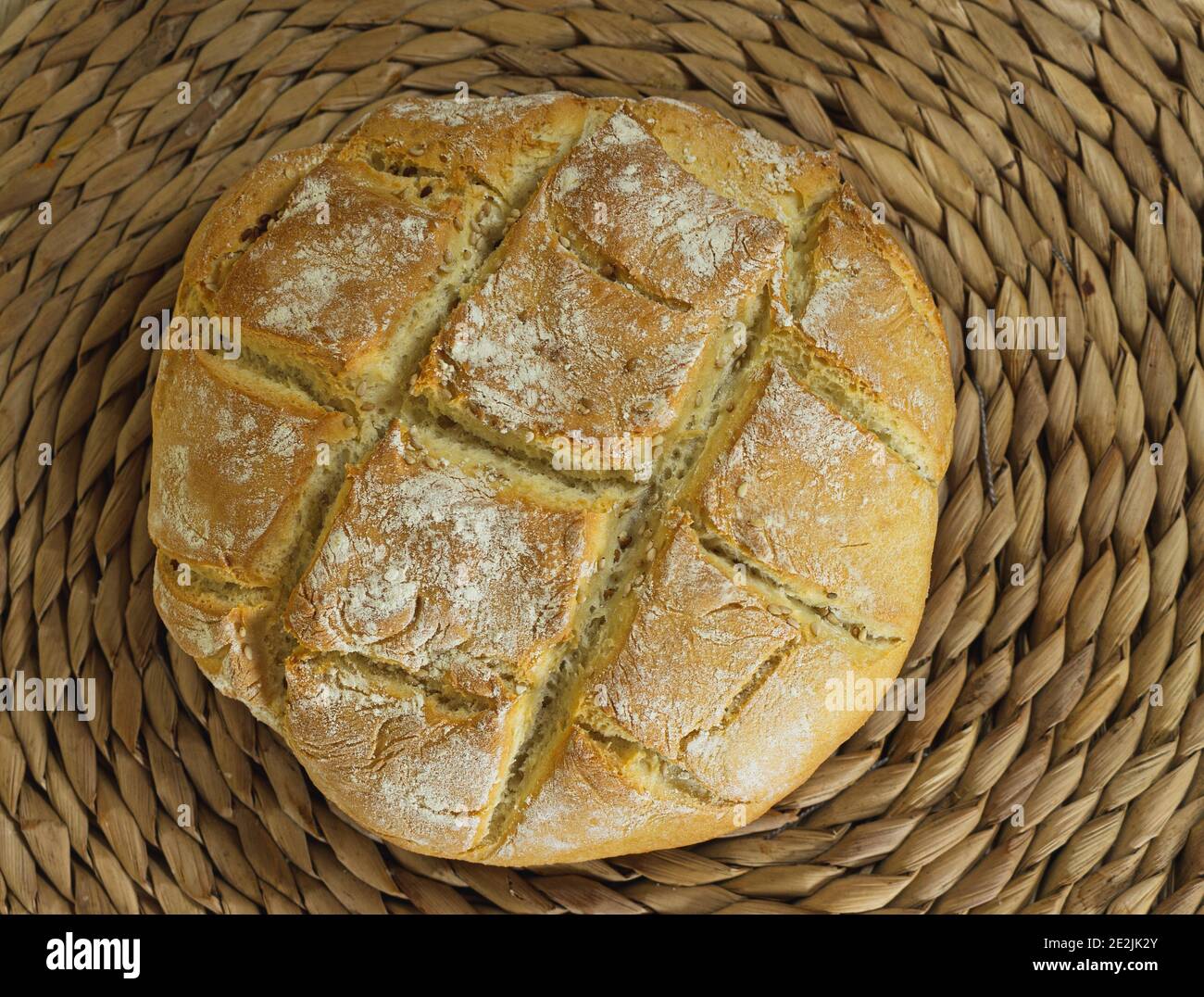 Homemade rustic bread loaf made with wheat flour on a wooden textured ...