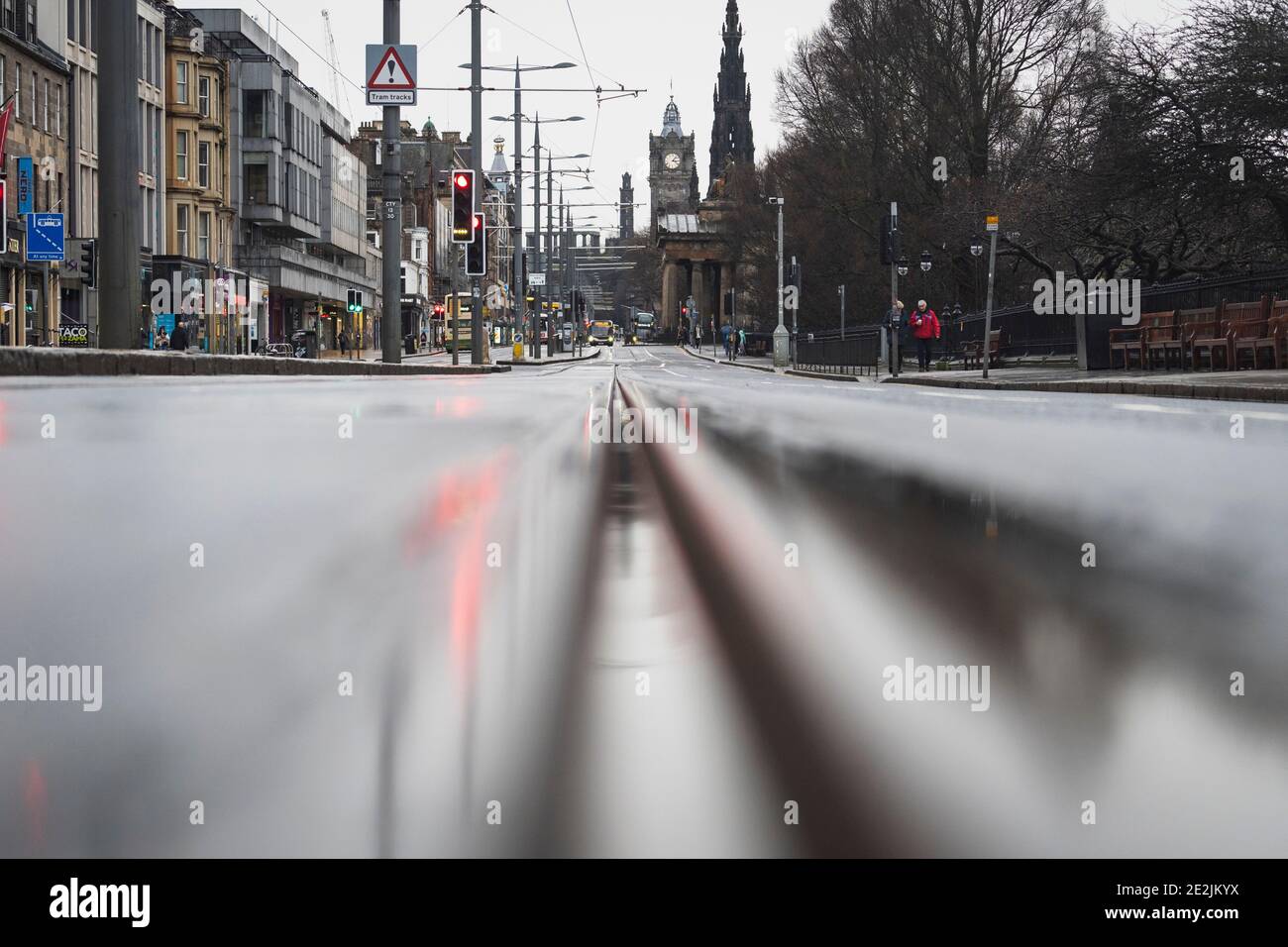 Edinburgh, Scotland, UK. 14 January 2021. Views of Edinburgh City Centre during national lockdown before click & collect and takeaway services from cafes and restaurants are further restricted following rule changes from Scottish Government. Pic. Traffic on princes Street is very quiet.   Iain Masterton/Alamy Live News Stock Photo