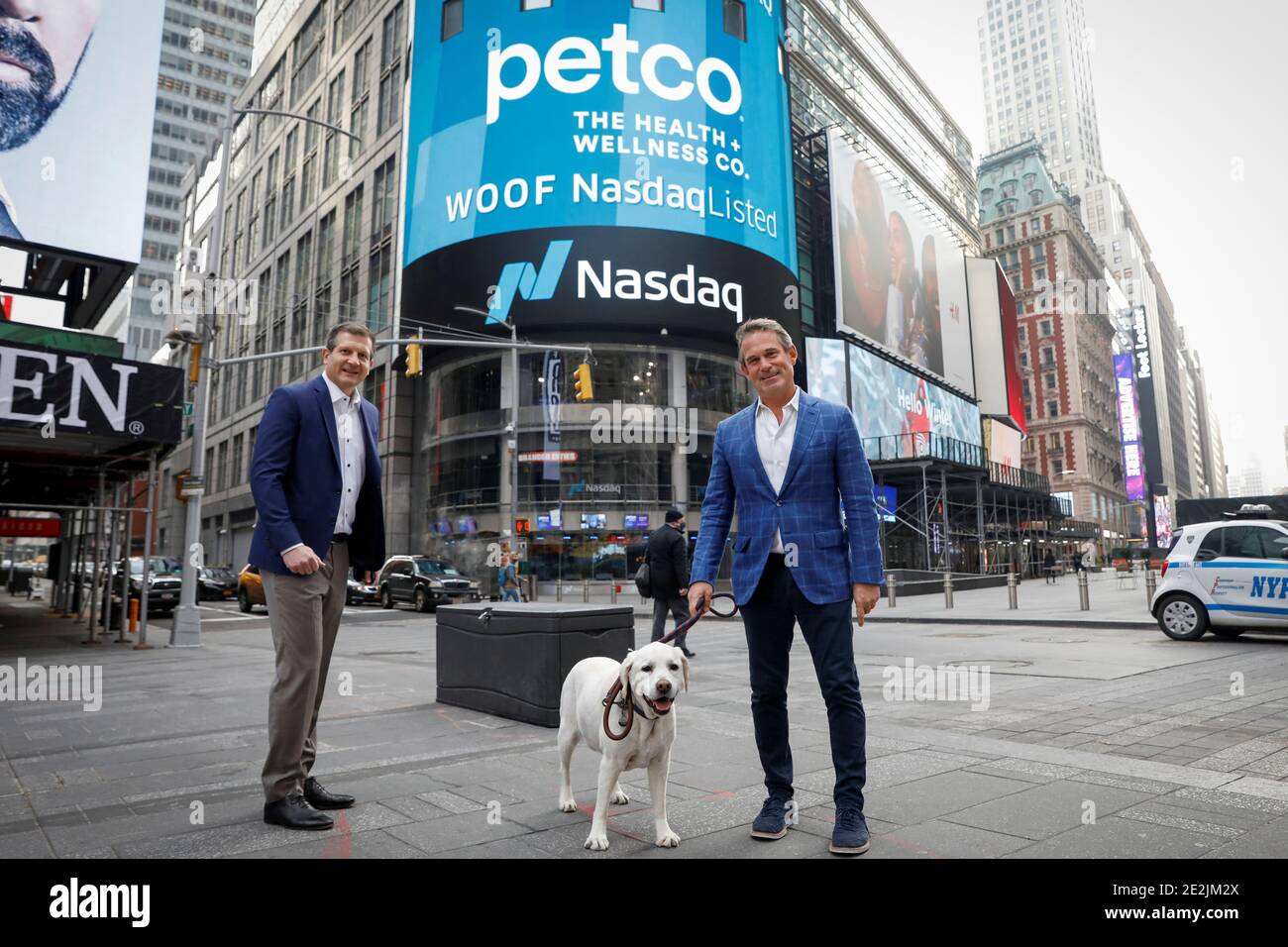 Ron Coughlin, CEO of Petco Health and Wellness Company Inc., poses with his dog Yummy and Mike Nuzzo, Petco COO, during the company's IPO at the Nasdaq Market Site in Times Square in New York City, U.S., January 14, 2021.  REUTERS/Brendan McDermid Stock Photo