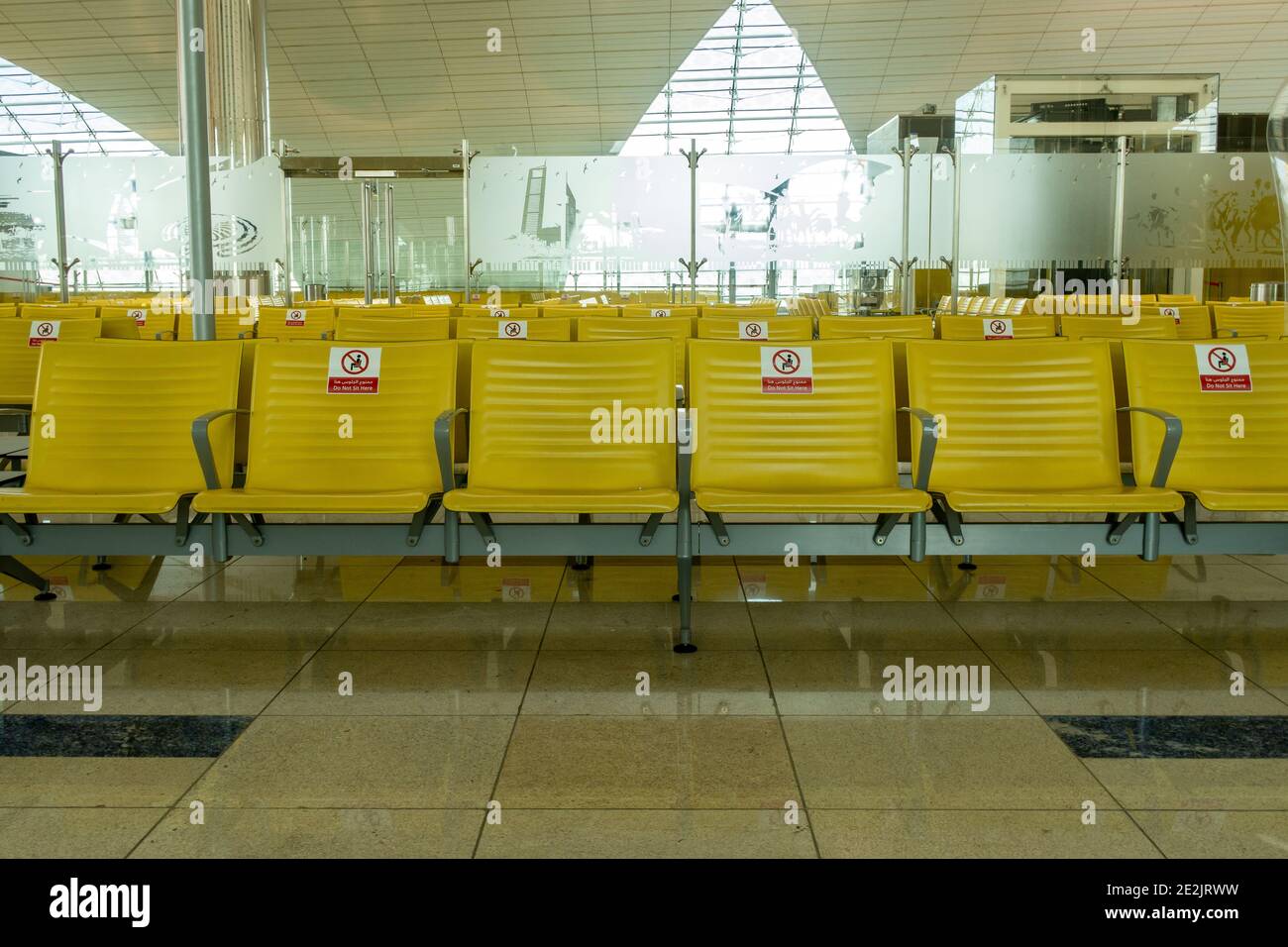 Dubai, UAE, 20.11.2020. Rows of empty seats at Dubai International Airport DXB terminal with Do not seat signs due to coronavirus pandemic, maintainin Stock Photo