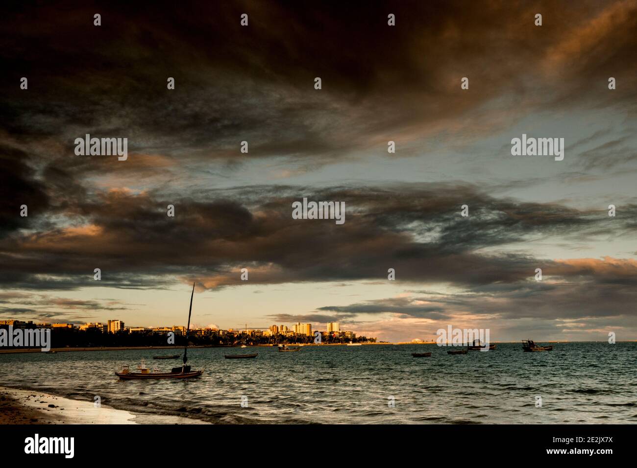 Sunset and tourist boats on a beach in Maceió, Brazil Stock Photo