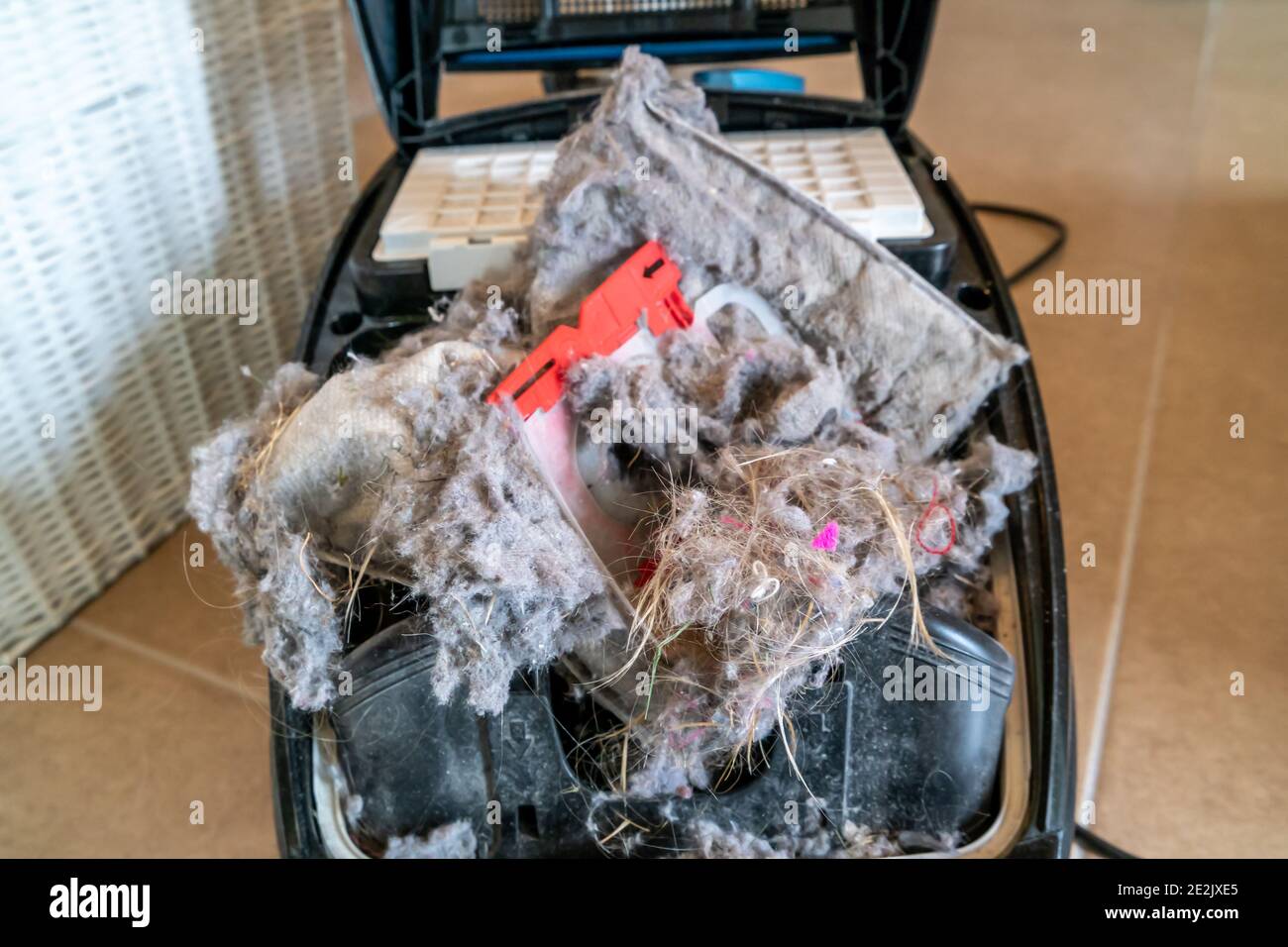 Exploded hoover dust bag producing much dirt. Stock Photo