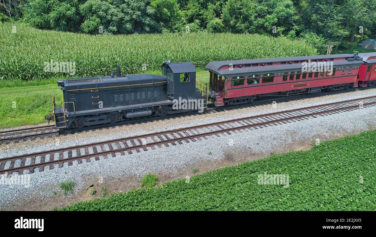 Aerial View of a Diesel Pulling Antique Passenger Cars on a Summer Day Stock Photo