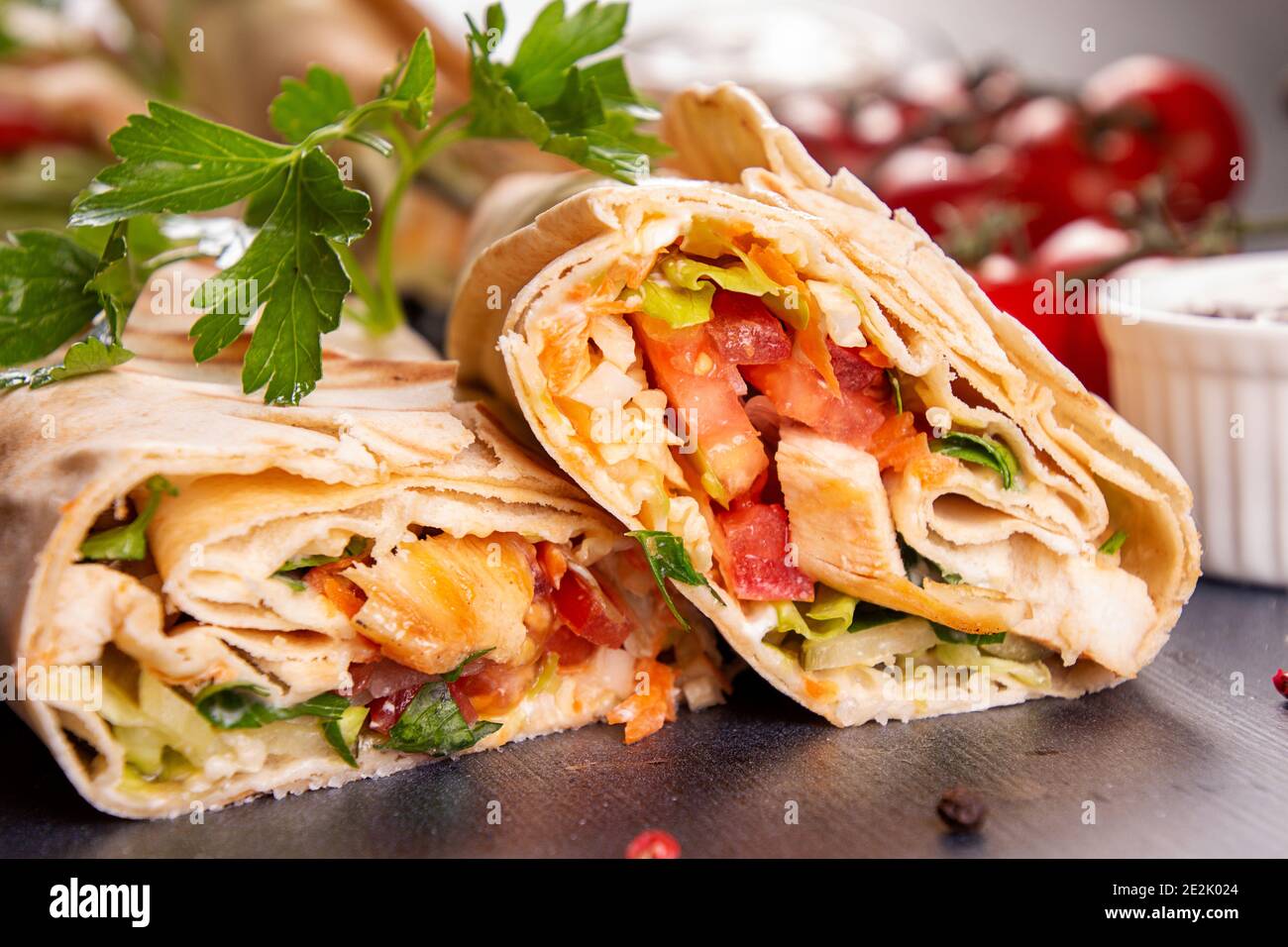Popular arabic turkish fastfood doner shawarma roll with meat and  vegetables on dark background Stock Photo - Alamy