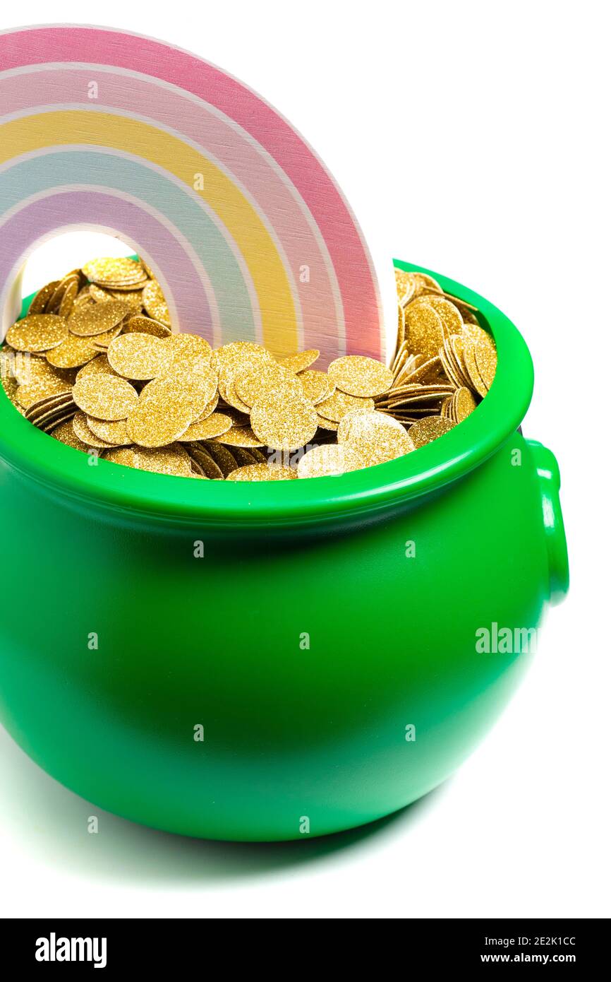 Green Pot Full of Golden Coins at the End of the Rainbow Stock Photo