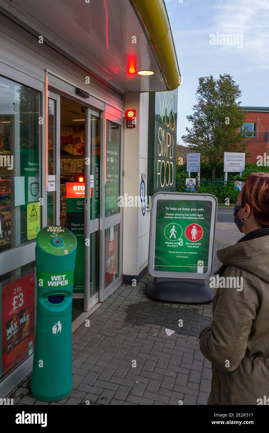 Woman waiting for the green light to enter a BP petrol station during the Covid-19 pandemic, Salisbury, UK. Stock Photo