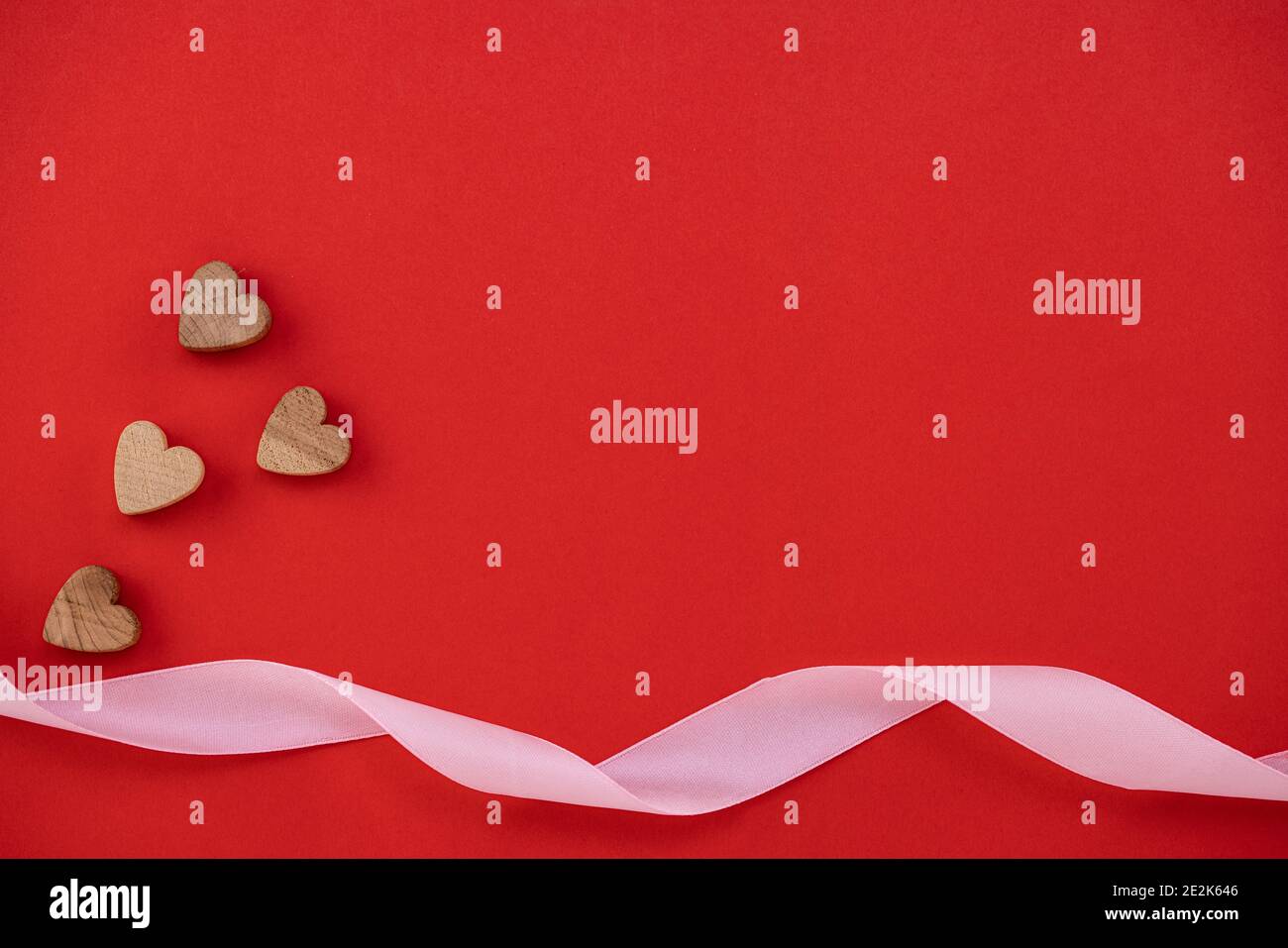 wooden hearts on red background with copy space Stock Photo - Alamy