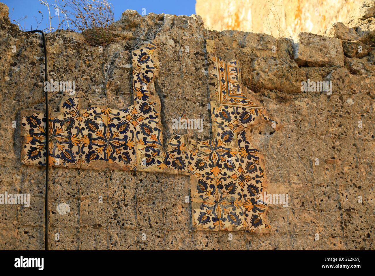 Broken tiles on Palmela castle wall, Setubal province, Portugal. Stock Photo