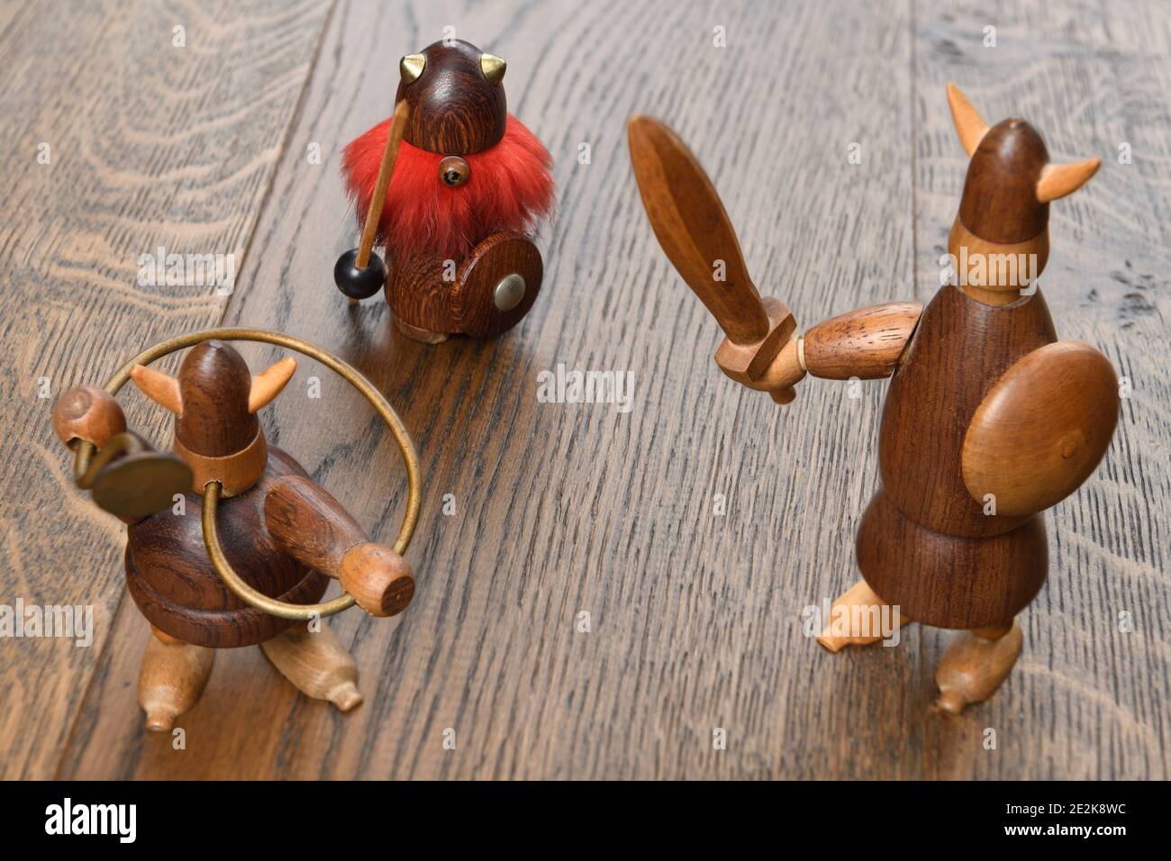 Three wood Viking figurines with sword trumpet and spear on wood planks Stock Photo Alamy