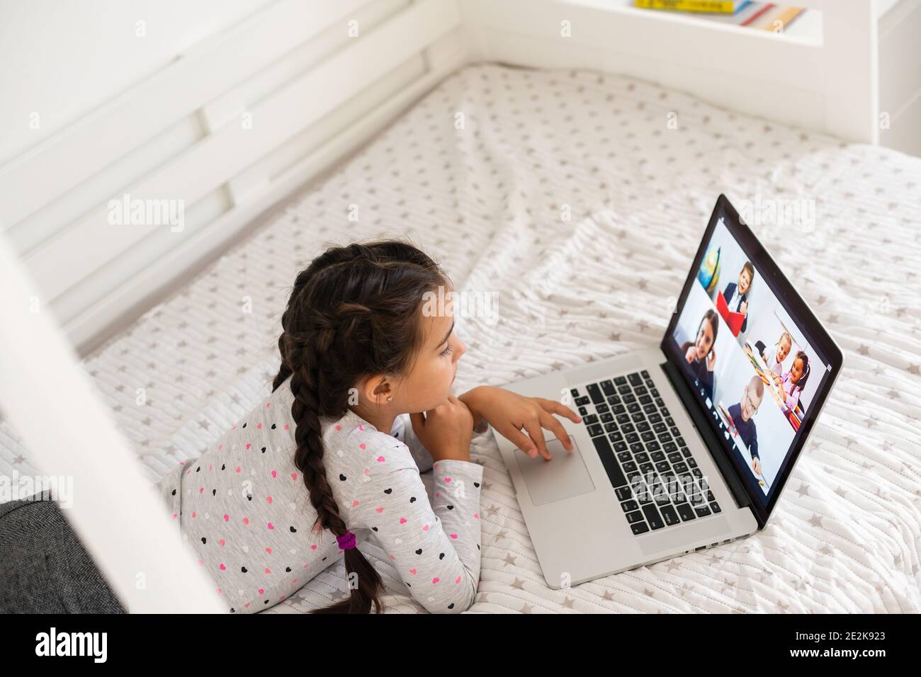 Little girl studying online using her laptop at home Stock Photo - Alamy