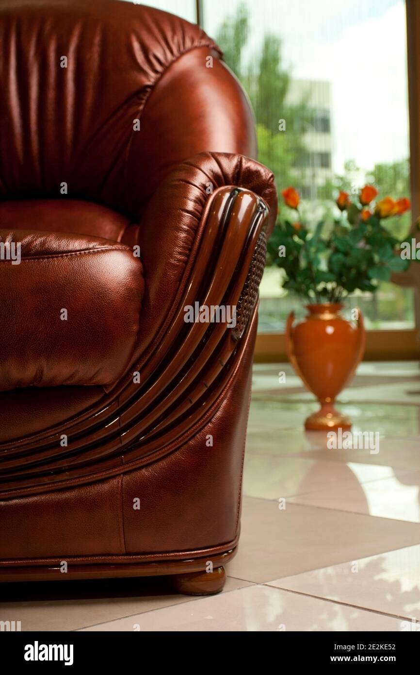 empty interior living room background in warm colors decorated with classic luxury leather soft chair, nobody Stock Photo