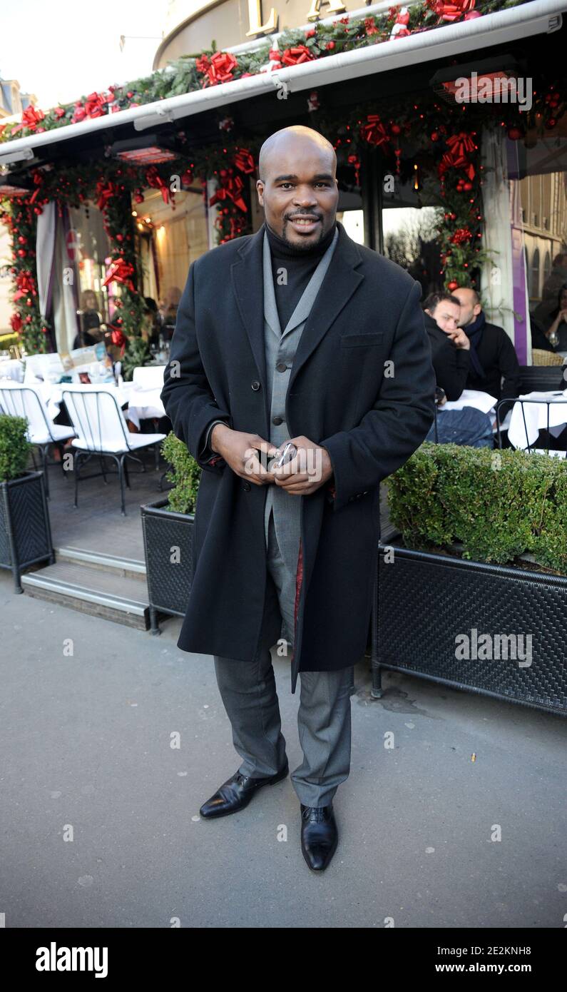 New heavyweight champion, French boxer Jean-Marc Mormeck poses as he exits the restaurant L'Avenue in Paris, France on January 4, 2010. Photo by ABACAPRESS.COM Stock Photo