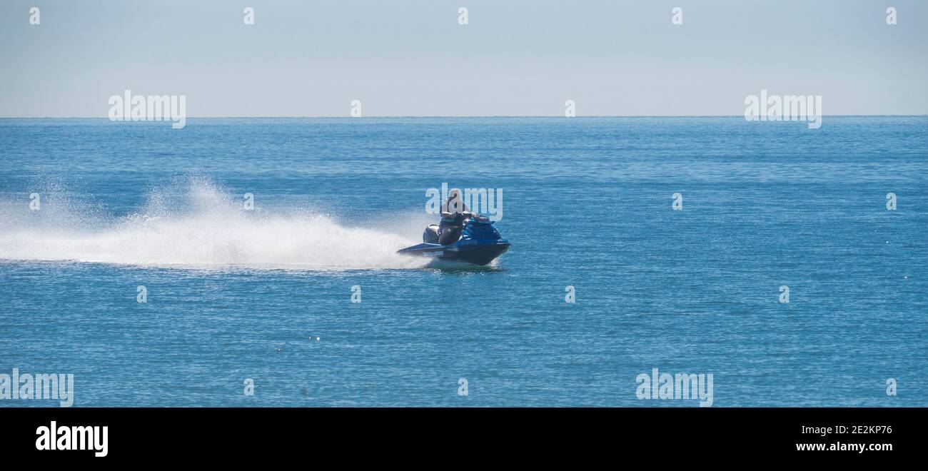 a personal watercraft speeding along Woorim Beach on Bribie Island, Queensland, Australia Stock Photo