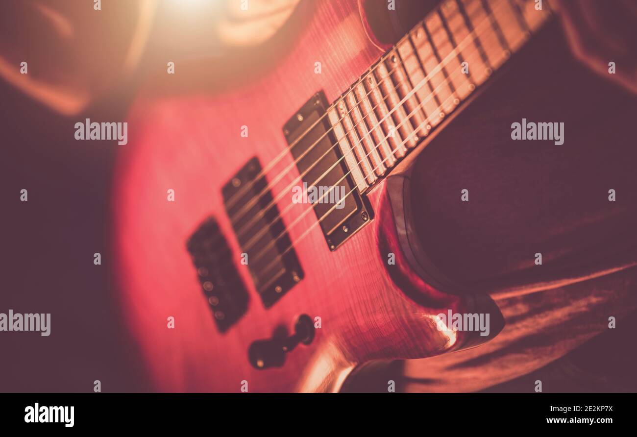 Music Industry Theme. Rockman Guitarist Playing Hard. Musician with Electric Guitar in His Hands Close Up. Stock Photo