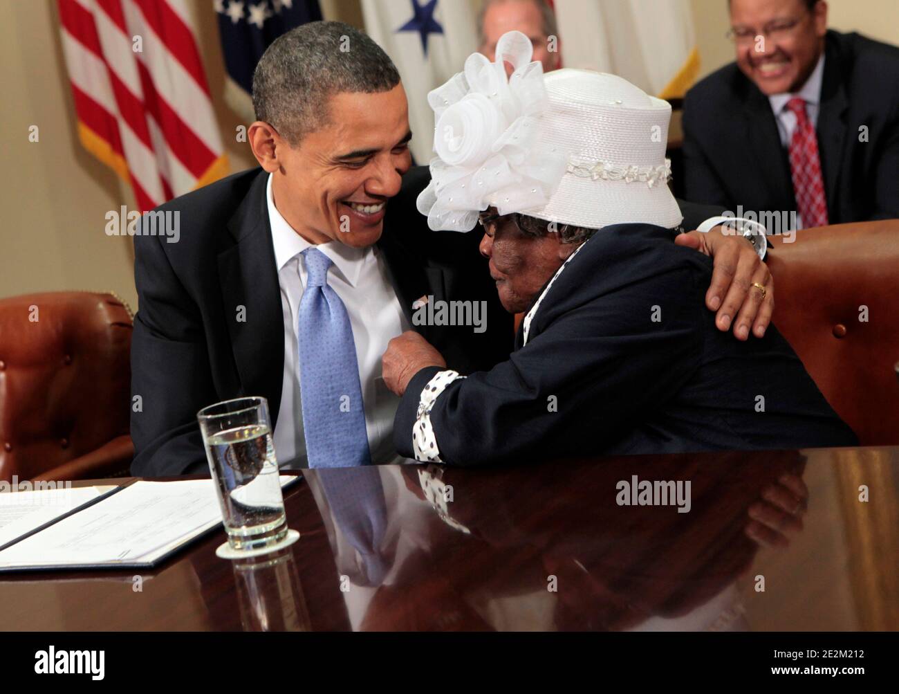 US President Barack Obama jokes with Mable Harvey before hosting a  conversation with a small group of African American seniors and their  grandchildren on the legacy of the civil rights movement at