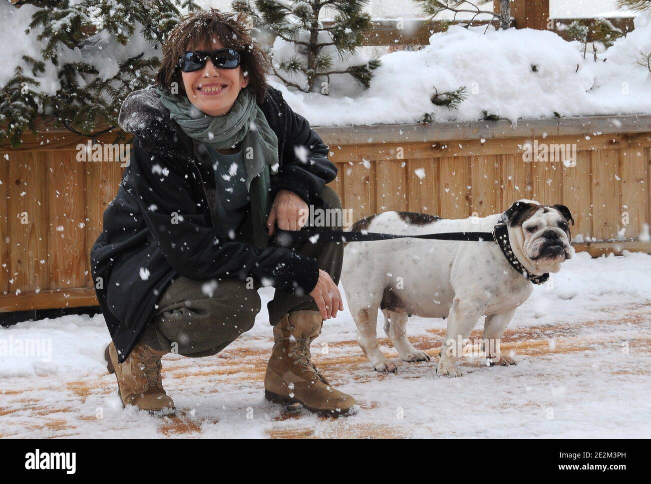 Jane Birkin and her dog Dora poses at a photocall under the snow