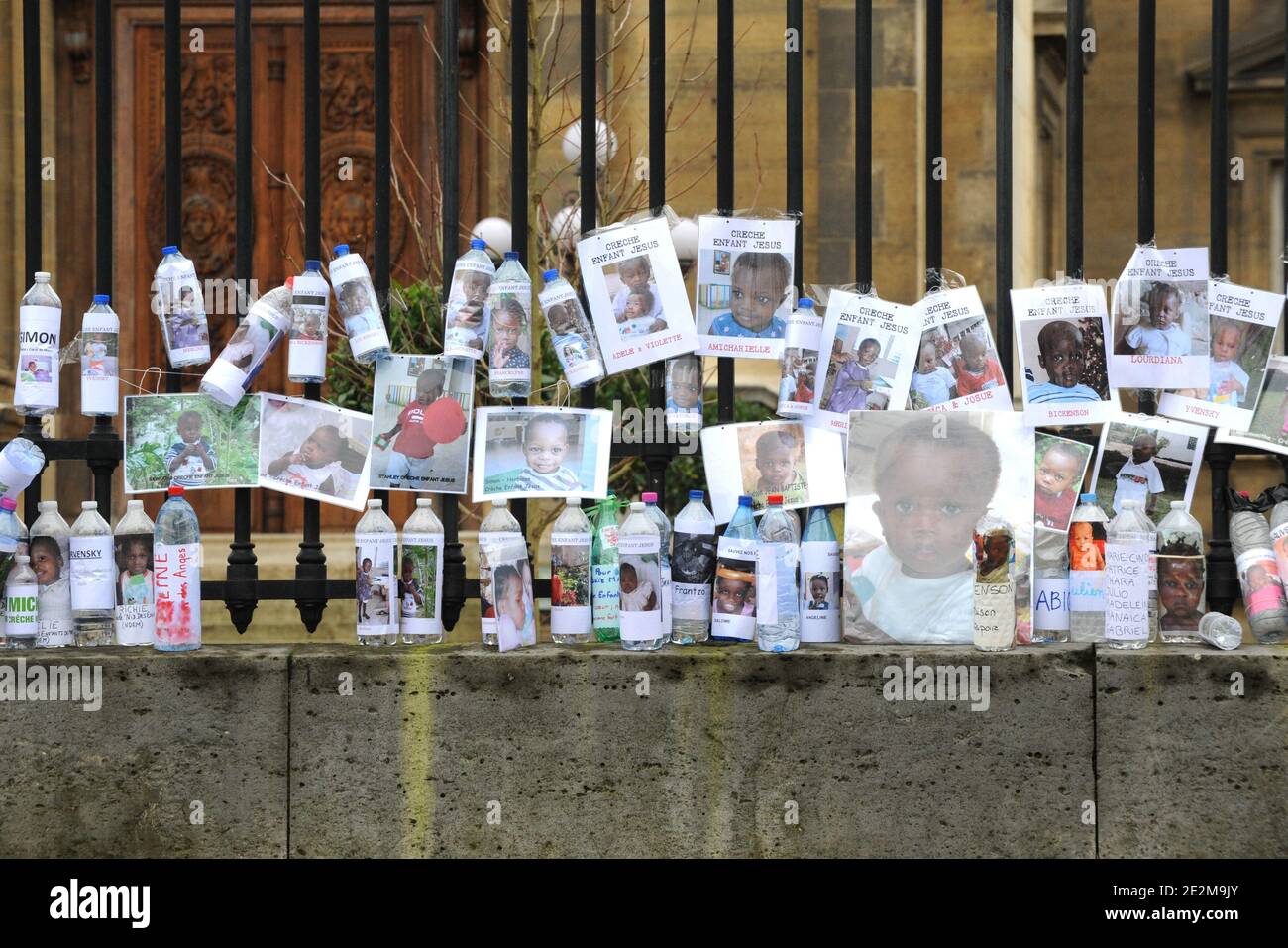 Water bottles placed bearing the photos and the names of Haitian orphans, during an action of French action group 'Collectif SOS Haiti Enfants Adoptes', or 'Haiti Adopted Children Emergency Action Group', in front of the French Foreign Ministry in Paris, Saturday, January 23, 2010. The group is asking for the immediate repatriation of all Haitian orphans whose adoption case is in process. Photo by Mousse/ABACAPRESS.COM Stock Photo