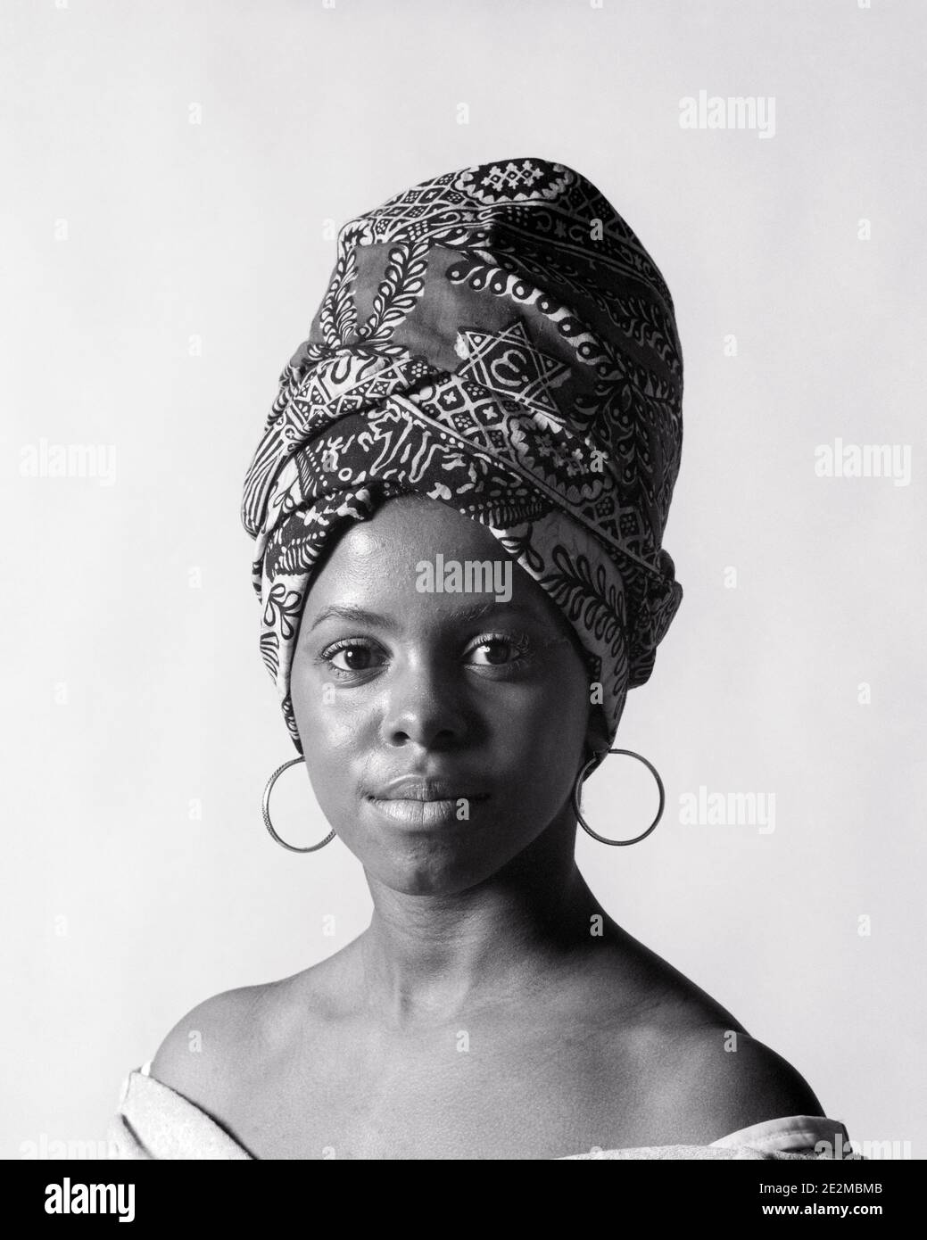 1970s PORTRAIT AFRICAN AMERICAN YOUNG WOMAN LOOKING AT CAMERA WEARING A TIGON A PRINT FABRIC HEAD-WRAP AND HOOP EARRINGS - g8000 HAR001 HARS SPANISH JOY LIFESTYLE CELEBRATION FEMALES RURAL HEALTHINESS COPY SPACE LADIES PERSONS CLOTH TRADITIONAL EARRINGS CARING SPIRITUALITY CONFIDENCE B&W EYE CONTACT MATERIAL HAPPINESS WELLNESS HEAD AND SHOULDERS STRENGTH STYLES AFRICAN-AMERICANS COURAGE AFRICAN-AMERICAN CHOICE KNOWLEDGE BLACK ETHNICITY LOUISIANA PRIDE CONCEPTUAL STYLISH TEENAGED TURBAN CREOLE WIDE-EYED CREATIVITY FASHIONS OMAN PERIOD YOUNG ADULT WOMAN BLACK AND WHITE DESCENT HAR001 Stock Photo