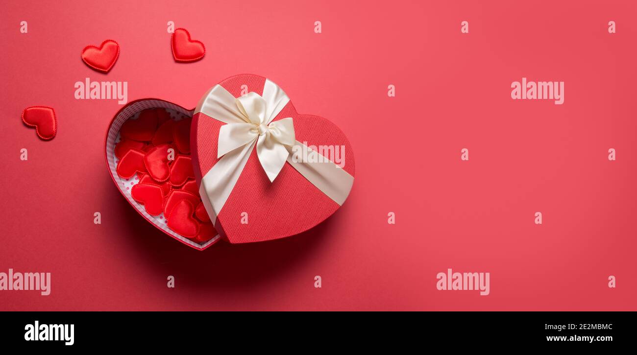 Valentine's Day romantic red heart box in woman hands on red background ...