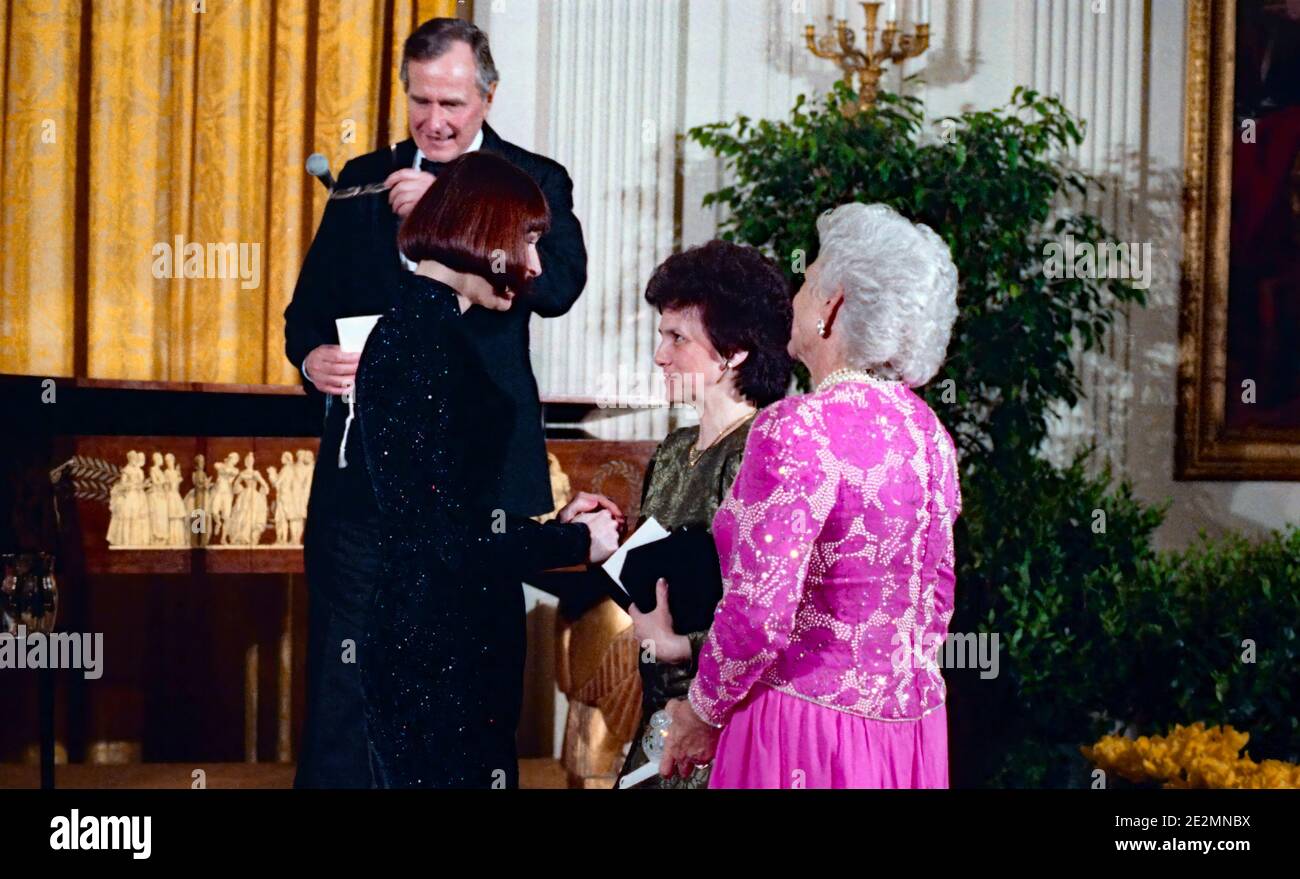 Washington DC. USA, March 20, 1991 State Dinner for Polish President Lech Walesa. After the meal, the guests are seated in the East Room and are formally entertained by a musical ensemble such as a pianist, a singer, an orchestra, or band of national renown. On past occasions, dancing has also been a component at the conclusion of a state dinner. Broadway singer Karen Akers sang 'Music of the Night' and Dream a Little Dream of Me' After her performance Ms. Akers greets Danuta Walesa and First Lady  Barbara Bush. Credit: Mark Reinstein / MediaPunch Stock Photo