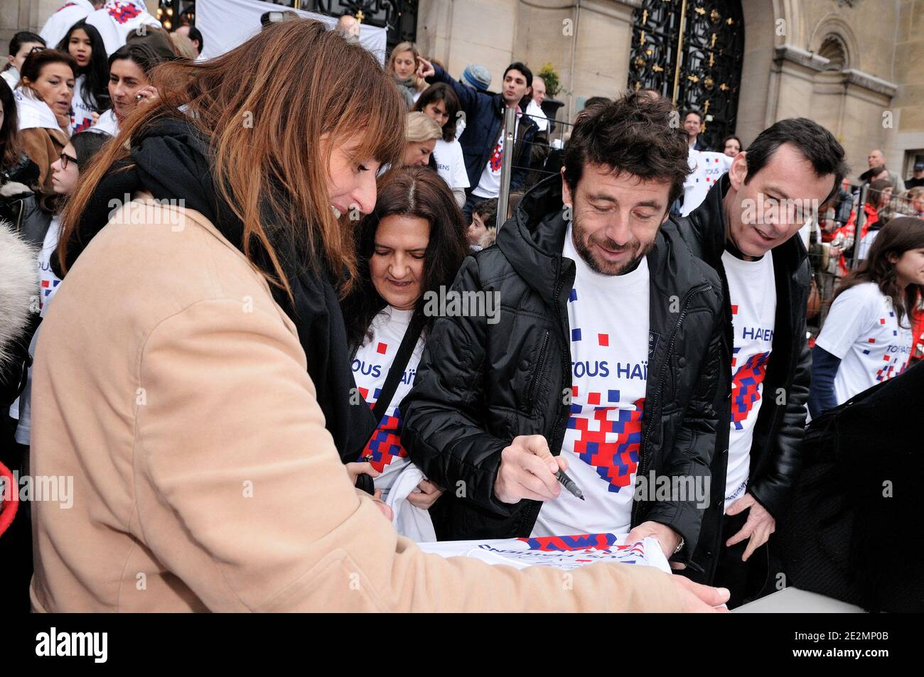 L-R) Nathalie Andre, Patrick Bruel and Jean-Luc Reichmann participate in a  meeting hosted by the French Red Cross for Haiti ,'Marchons pour Haiti,  tous Haitiens', 'Neuilly bouge pour Haiti' in Neuilly-sur-Seine, near