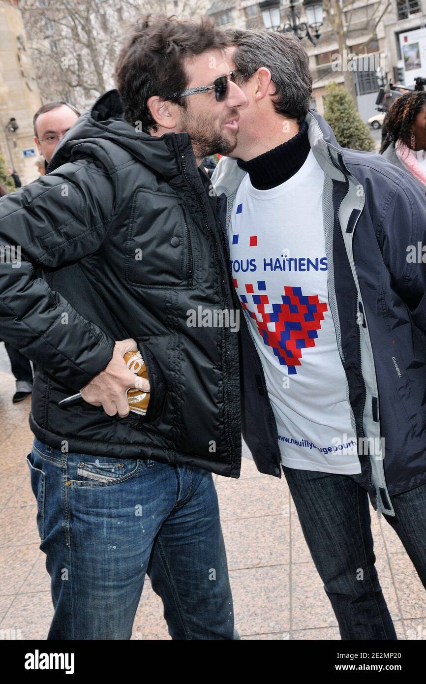 Patrick Bruel (L) and Neuilly-sur-Seine mayor Jean-Christophe Fromantin  participate in a meeting hosted by the French Red Cross for Haiti  ,'Marchons pour Haiti, tous Haitiens', 'Neuilly bouge pour Haiti' in  Neuilly-sur-Seine, near