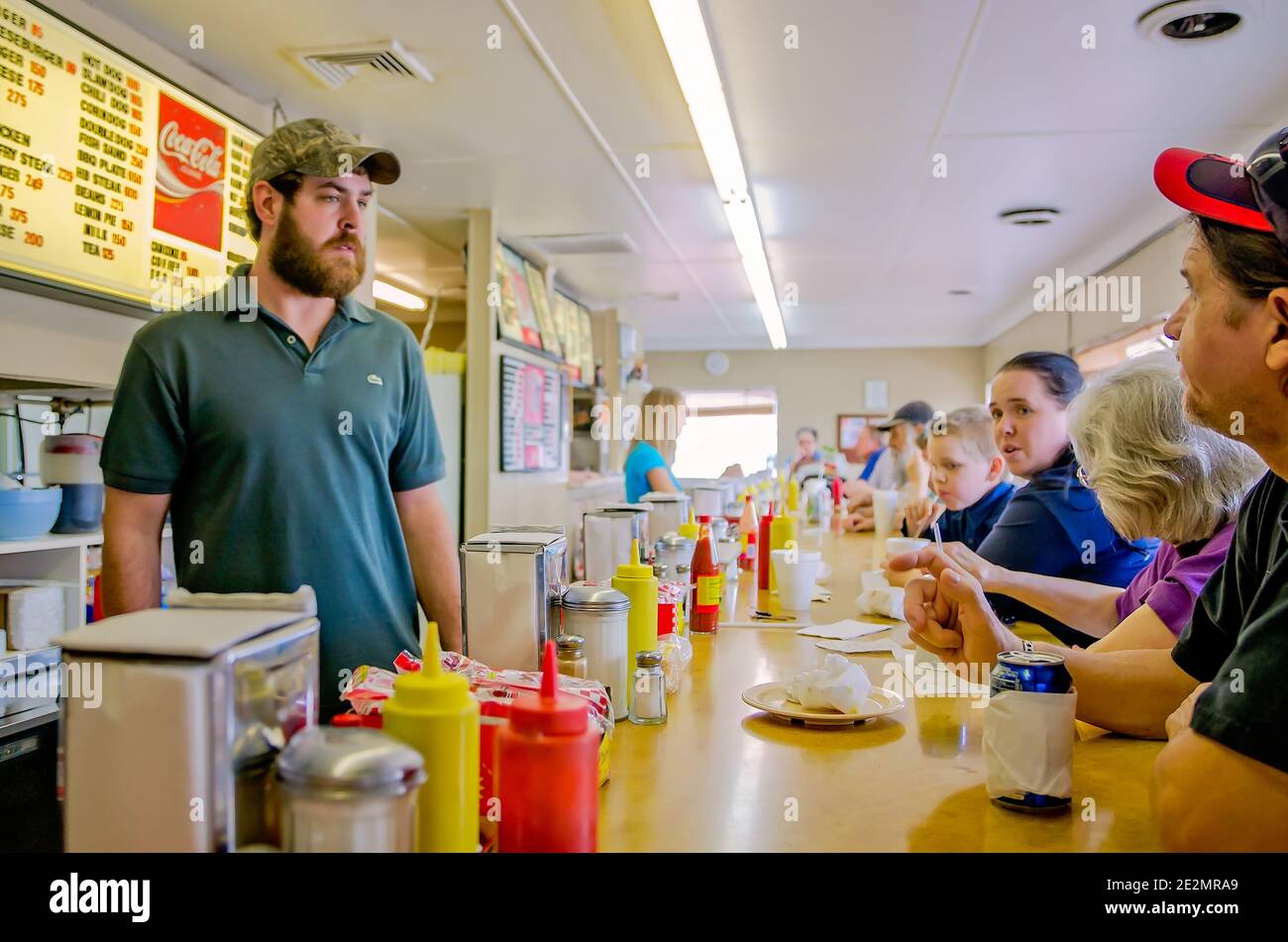 A clerk waits on lunch customers at the White Trolley Cafe, March 14, 2012, in Corinth, Mississippi. The diner is known for its slugburger. Stock Photo