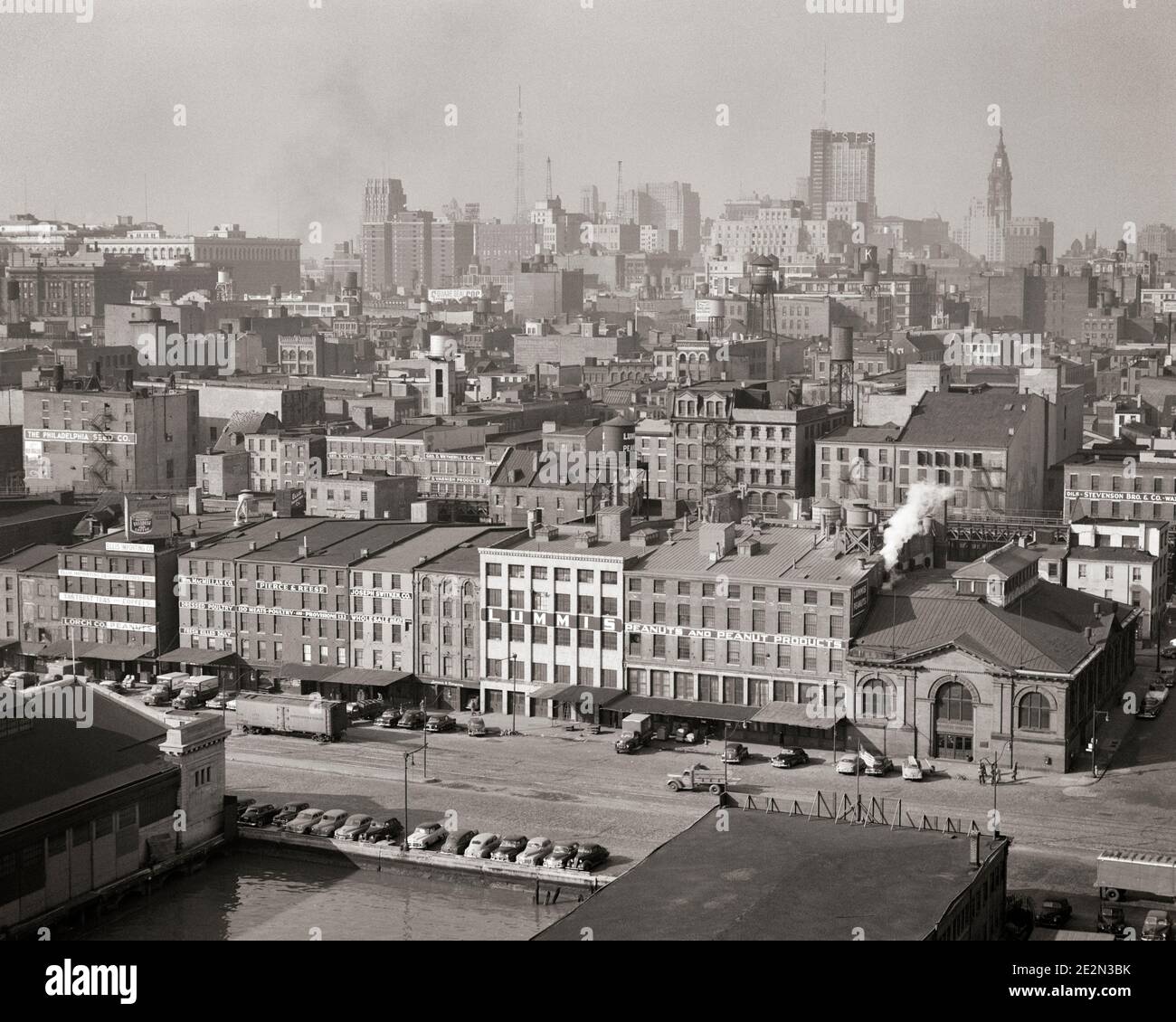 1950s MANY INDUSTRIAL BUILDINGS AND WAREHOUSES ALONG WATERFRONT AERIAL VIEW TO CENTER CITY SKYLINE PHILADELPHIA PENNSYLVANIA USA - p1408 HAR001 HARS COMMONWEALTH STRUCTURES KEYSTONE STATE WAREHOUSE EDIFICE DELAWARE RIVER SIDE-BY-SIDE WATERFRONT AERIAL VIEW BLACK AND WHITE CITY OF BROTHERLY LOVE HAR001 OLD FASHIONED Stock Photo