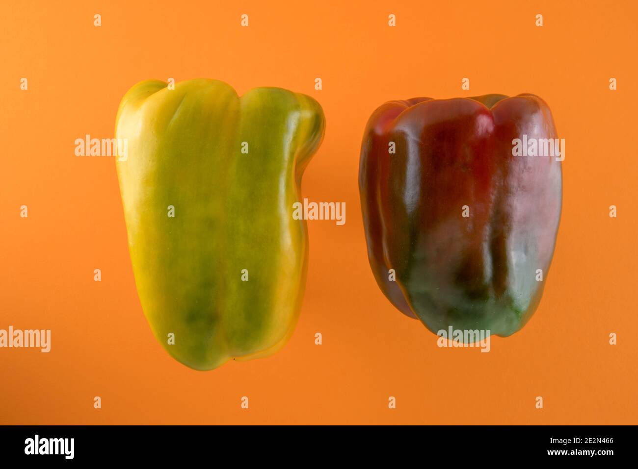 green red yellow bell peppers isolated on orange background Stock Photo ...