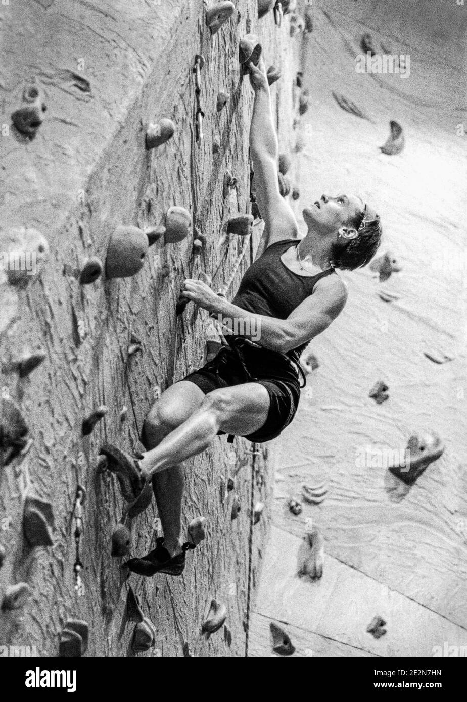 A woman bouldering at an indoor climbing gym Stock Photo Alamy