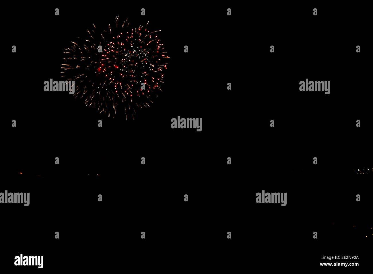 fireworks in orange color with red points black sky with copy space Stock Photo