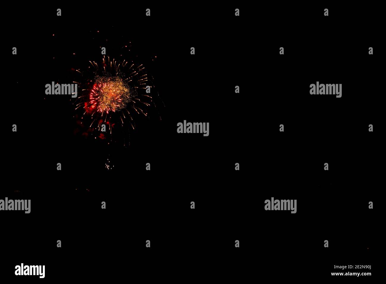 fireworks in orange and red color points black sky with copy space Stock Photo