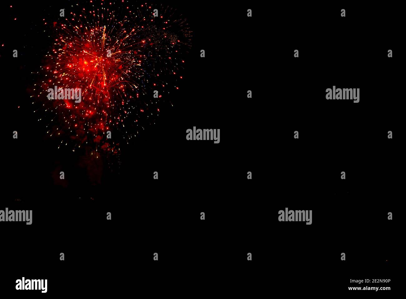fireworks in orange color with red points black sky with copy space Stock Photo
