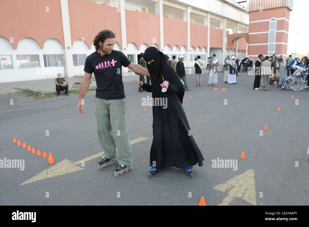 Roller trainer Fabrice teaches young Yemenite woman Altaf how to use the roller blades, as French rollerbladers are skating with Yemenite disabled people, in a rallye around the 'Al-Saleh' mosque in Sana'a, Yemen, on February 28, 2010. Yemen is seen as a 'dangerous' country, with terrorism threat for westerners. The event was meant to draw attention to Yemenite disabled special needs, and ask for laws to support them. Photo by Ammar Abd Rabbo/ABACAPRESS.COM Stock Photo